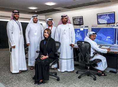 Nouf Al Afifi with her male colleagues at Sheikh Zayed Air Navigation Centre. Victor Besa / The National