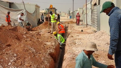 Labourers carry out work on a project funded by the UAE to improve water, sanitation and hygiene for Syrian refugees in the Zaatari camp in Jordan. Courtesy UNCHR