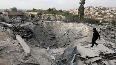 Damage at the site of an air strike in Toura. EPA