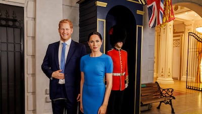 The waxworks of Britain's Prince Harry and his wife, Meghan, stand next to suitcases at the Madame Tussauds museum in London. Reuters