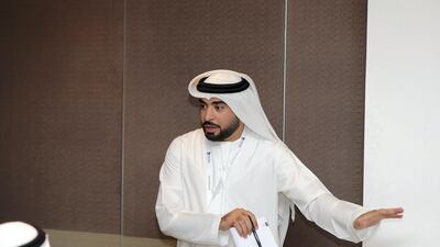 Ahmad Al Bloushi, director general of the Industrial Development Bureau, hosts a 'majlis' briefing to set out new measures to help companies. Chris Whiteoak / The National