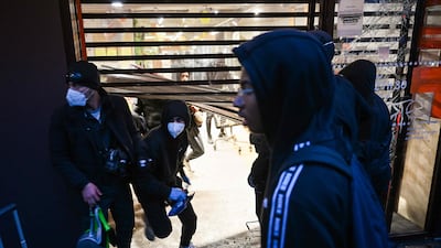 People enter a ransacked Franprix store, in central Paris. AFP