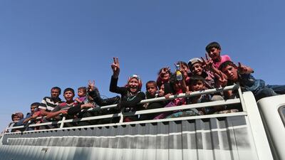 Civilians react atop a pick-up truck after they were evacuated by the Syria Democratic Forces (SDF) fighters from an ISIL-controlled neighbourhood of Manbij, in Aleppo Governorate, Syria. Rodi Said / Reuters