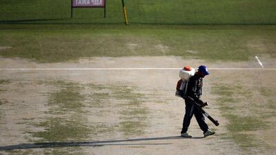 An Indian worker prepares the pitch for the ICC World Twenty20 2016 cricket tournament at Dharamsala on Tuesday. Tsering Topgyal / AP / March 9, 2016
