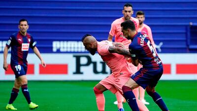 Eibar's Gonzalo Escalante, right, challenges Barcelona's Arturo Vidal. AFP