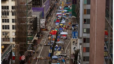 Top, Nathan Road occupied by pro-democracy protesters in the Mongkok shopping district of Hong Kong on November 12, 2014, and bottom, the same location on September 16, 2015. Reuters