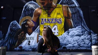 A woman looks up at a mural of Bryant and Gianna in Los Angeles. AP