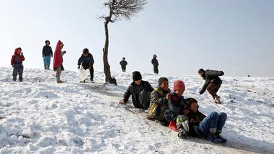 Afghan boys slide down a snow-covered slope in Kabul, Afghanistan. Mohammad Ismail / Reuters