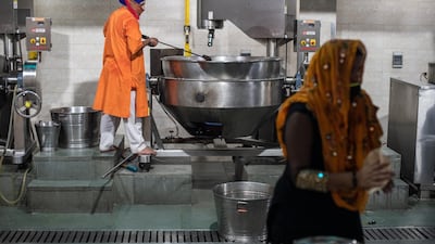 Volunteers prepare meals to be donated to patients across the city suffering from Covid-19, made at the Gurudwara Bangla Sahib, in New Delhi. Getty Images