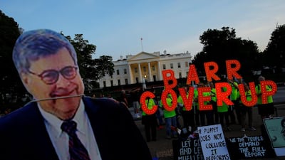 A cardboard cutout of US Attorney General William Barr is seen as protesters hold signs which read 'Barr Coverup' at the White House in Washington. Reuters