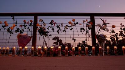 Flowers and candles are seen at a memorial near Truth Aquatics. Reuters