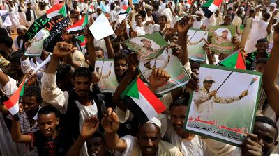 Supporters of Lieutenant General Mohamed Hamdan Dagalo, deputy head of the military council and head of paramilitary Rapid Support Forces (RSF), cheer as he arrives at a meeting in Aprag village, 60km away from Khartoum, Sudan. Reuters