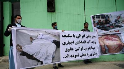 Civil society activists hold banners and shout slogans against the Iranian government during a protest in front of the Iranian embassy in Kabul on May 11, 2020. AFP