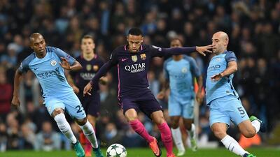 Barcelona forward Neymar on the ball as Manchester City midfielder Fernandinho, left, and full-back Pablo Zabaleta defend. Shaun Botterill / Getty Images