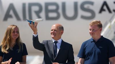Olaf Scholz receives a model of an Airbus Zero E aircraft from trainees on the first day of the ILA Berlin 2022 air show in June. Getty Images