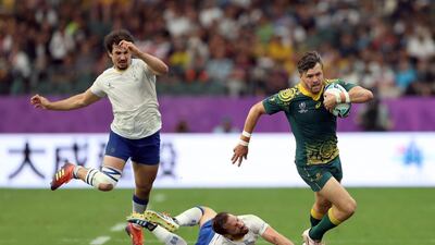 Adam Ashley-Cooper of Australia avoids Felipe Berchesi and Rodrigo Silva of Uruguay. Getty