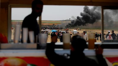 Palestinians protesters burn tires at the border fence with Israel, east of Jabalia in the central Gaza city. Mohammed Abed / AFP Photo