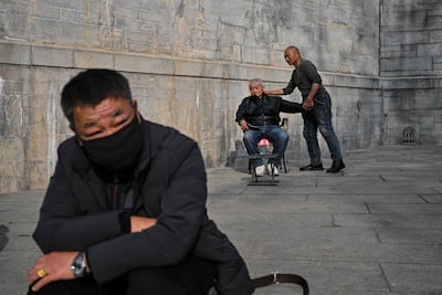 A man gives a massage to an elderly person in China's central Hubei province. AFP