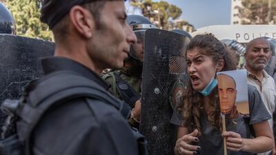 Riot police block angry demonstrators before dispersing them during a rally protesting the death of Nizar Banat. AP.