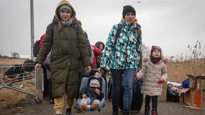 Refugees, mostly women with children, arrive at the border crossing in Medyka, Poland, Saturday, March 5, 2022, after fleeing Russian invasion in Ukraine. (AP Photo / Visar Kryeziu)