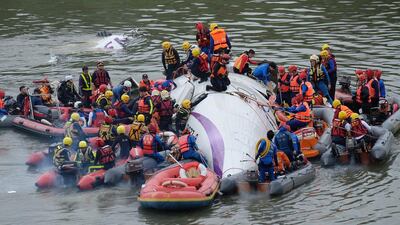 Teams of rescuers in rubber rafts clustered around the wreckage. Sam Yeh / AFP Photo