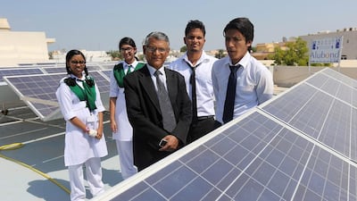 Principal Mir Hasan and pupils, from left, Asthma Amree, 12, Zarin Isra, 13, Mohammed Nur, 18, and Fahad Bashar, 17, with the solar panels that now power all of the school’s lighting, computers and fans. Sammy Dallal / The National