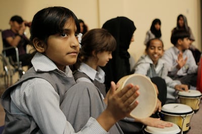 Moisa Al Balushi, 9, performs with other children at Al Ain Centre for Care and Rehabilitation in 2009, following a week-long music therapy workshop supported by the Abu Dhabi Music & Arts Foundation. Ryan Carter / The National