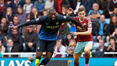 Manchester City's Yaya Toure, left, and West Ham's Stewart Downing in action during their English Premier League match at Upton Park in London on October 25, 2014. Sean Dempsey / EPA