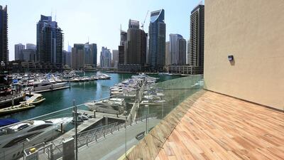 the most striking thing about the Marina-facing apartment is the view, with the apartment designed so that residents get a full view of the boats on the water and the twinkling lights of the towers from the lounge, bedroom and bathroom. Satish Kumar / The National