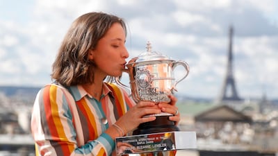 Poland's Iga Swiatek poses with the trophy after winning the French Open tournament at the Galeries Lafayette Rooftop, Paris. Reuters