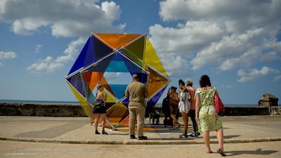 People observe new installations at the inauguration of the Havana Biennial's open-air exhibition 'Detras del Muro' (Behind the Wall). AFP