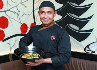 UDN chef Jun Espiritu holds up a bowl of ramen. Victor Besa / The National