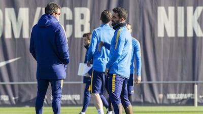 Barcelona’s Arda Turan talks to manager Luis Enrique during the team’s training session on Tuesday in Spain. Quique Garcia / EPA