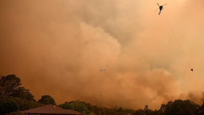 A firefighting helicopter in action as the Grose Valley Fire approaches Kurrajong Heights, NSW. EPA