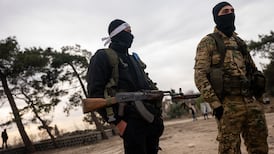 Fighters with the insurgent group Hayat Tahrir patrol in the city of Homs on January 22, 2025. Getty Images