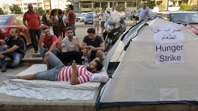 Lebanese 'You Stink' activists sit in front of their tent during a hunger strike against minister Mohammed Machnouk, calling for him to resign over a rubbish disposal crisis, in front of the Environment Ministry in downtown Beirut on September 3. EPA