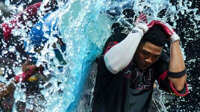 Cincinnati Reds' Noelvi Marte is doused with water after hitting a winning RBI against the Chicago Cubs. AP Photo