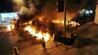 Tyres burn on the outskirts of Bahrain's capital, Manama, last Monday. The arrest of suspected terrorists has led to outbreaks of violence across the country in the run-up to the October 23 election.