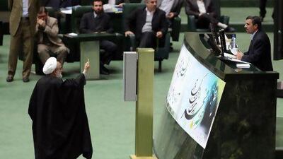 An Iranian member of parliament raises objections as Iranian President Mahmoud Ahmadinejad delivers a speech to parliament in Tehran this month. Atta Kenare / AFP