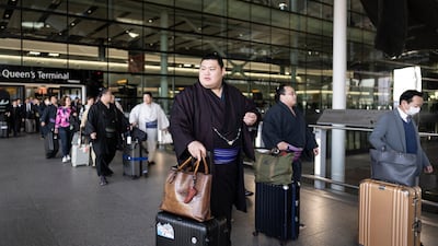 Sumo wrestlers arrive at Heathrow Airport on Saturday for a tournament in London. Getty Images