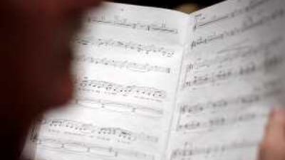 A member of the choir studies a songsheet during the final week of rehearsals for The Lord of the Rings Symphony.