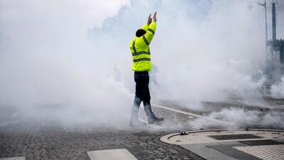 A yellow vest protester stands amid smoke during a demonstration in Paris, France, 08 December 2018. EPA
