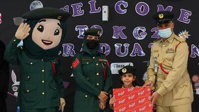 Hoor Hadad with Dubai Police officers and mascot Amna. Photo: Dubai Police