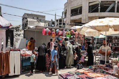 Palestinians shop at Al Zawiya market, in Gaza. Getty Images