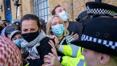 Protesters jostle with police outside the Defence and Security Equipment International fair at ExCel London. PA