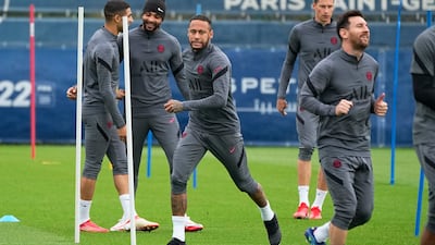 Neymar, centre, with Lionel Messi, right, during PSG's training session. AP