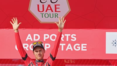 Lucas Plapp of Ineos Grenadiers celebrates on the podium after receiving the red jersey on the second stage of the UAE Tour. AFP