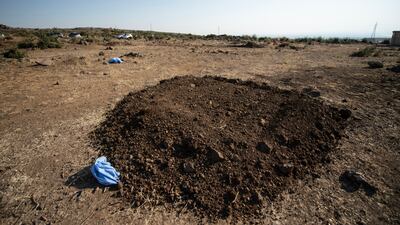 One of the mass graves in Al Raha area of Sweida, where the Druze hijab is placed as a symbol of the people.