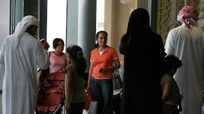 Two nannies accompany a family at Dubai Mall. It is estimated that at least tens of thousands of people in the UAE are employed as domestic workers. Pawan Singh / The National