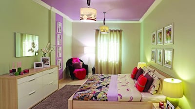 AFTER — Stylist solutions: Having recently won a battle against a serious illness, Heba Sayyed Mohammed Sadiq wanted a new room that reflected her new outlook on life. Light wood and white gloss furniture were introduce to give the space a more modern feel, while walls were painted in mint green with one accent wall in a warm orchid share. Frames were mounted on walls to fill up the long, asymmetrical column. Another large wall space was filled with contrasting frames and a series of wall art. Additional ceiling lights and a painted ceiling added a dash of drama to the room to make it look and feel cosier.